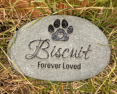 Decorative engraved stone with paw shape with heart in the middle over pet's name in decorative script and a memorial saying of "Forever Loved" underneath the name